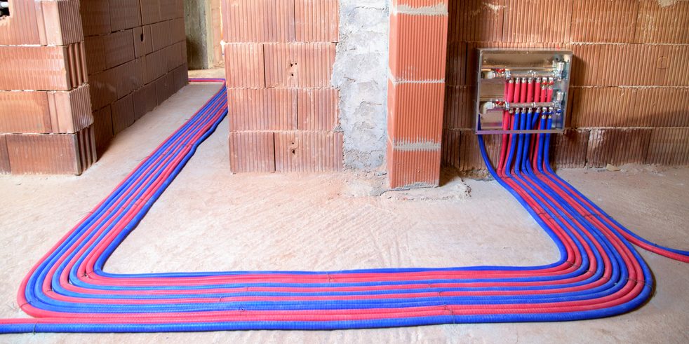 Red and blue heating pipes on the floor